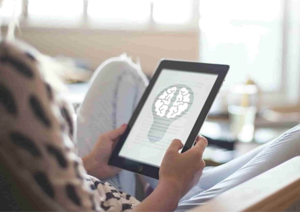 Person using tablet with brain graphic likely to be healthcare professional
