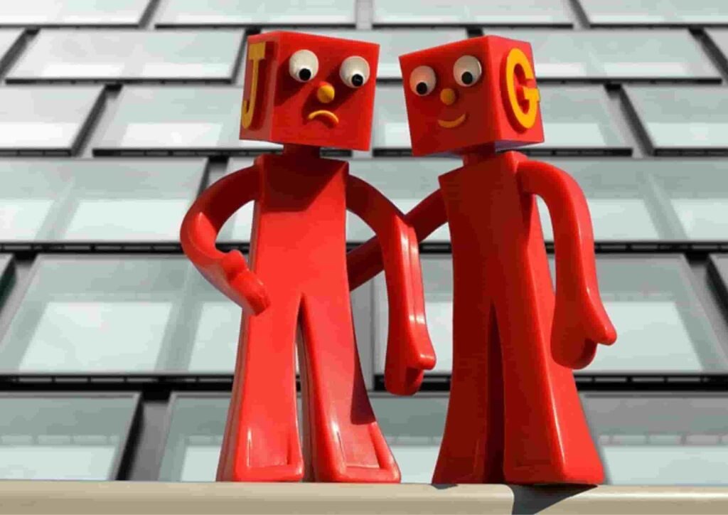 Two red cartoon characters talking standing on the edge of the building 