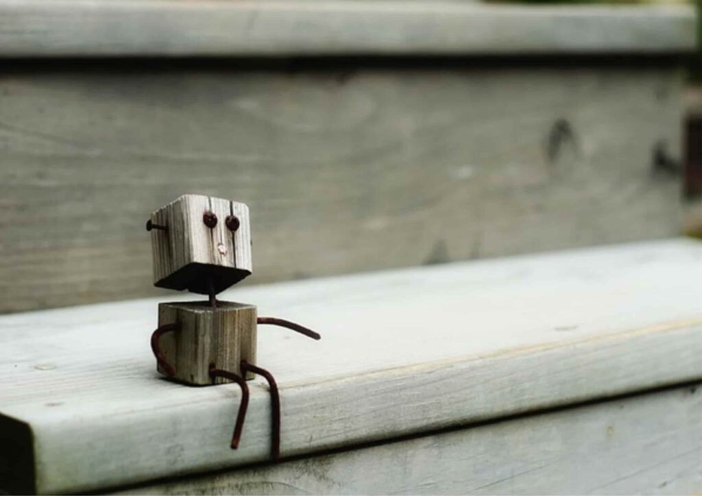 small cute robot sitting alone looks like waiting for something