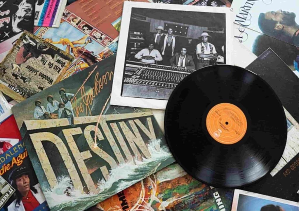 collection of vintage vinyl records and album covers, including *“Destiny”* by The Jacksons, spread across a colorful backdrop — perfect inspiration for AI album cover generators.